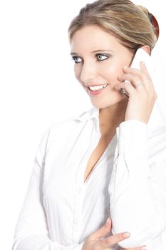 Attractive young blonde woman talking on a mobile phone standing at an angle looking away from the camera, natural studio portrait on white