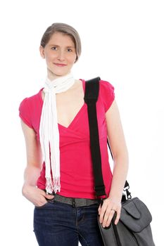 Stylish casual woman with sling bag wearing jeans, a red summer top and a decorative neck scarf standing in a relaxed pose with her hand in her pocket on white