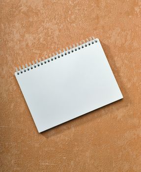 spiral notebook on painted background