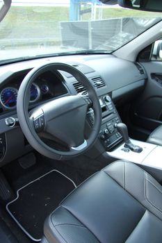 Dashboard and interior of a brand new car, leather and stainless steel