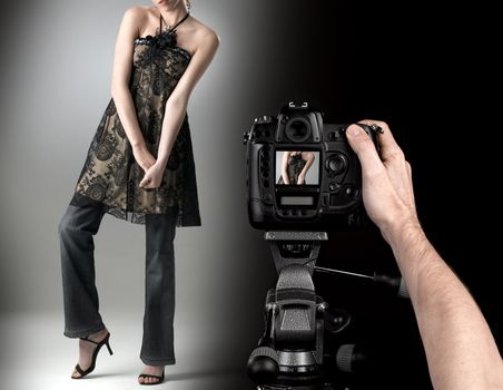 professional photographer at studio fashion shot with a model