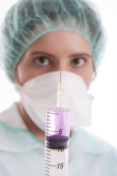 Nurse holding a syringe - isolated over white