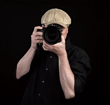 A photographer with a nice camera on black background