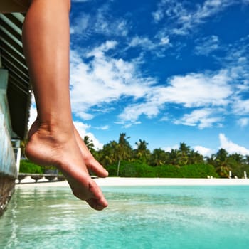 Woman's legs at beach jetty