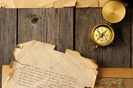 Antique brass compass over old map