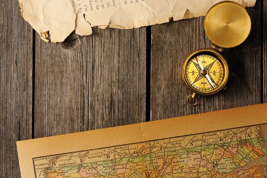 Antique brass compass over old map