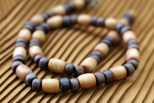 oval wooden beads on yellow background