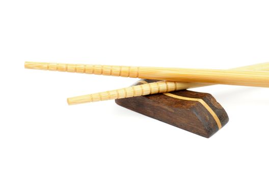 Pair of Beige Chopsticks and Brown Hasioki Cross Section on white background