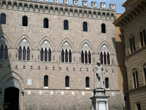 Siena - Salustio Bangini monument on the background of magnificent architecture