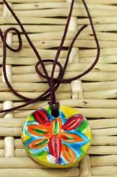 clay handmade amulet red blue and yellow