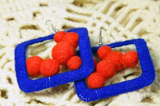 Knitted earrings on the knitted scarf. Handmade.