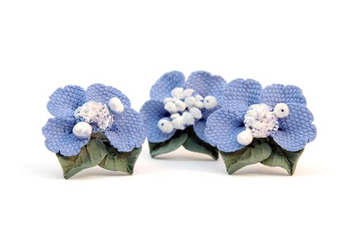 Earrings blue flower of the plastic clay isolated on a white background