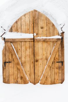 wooden door of rough planks. Input with Snow Castle