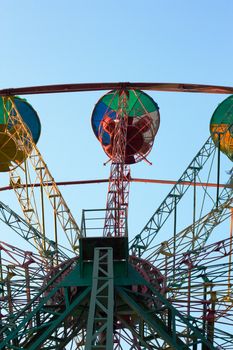 Ferris wheel on the blue sky background 