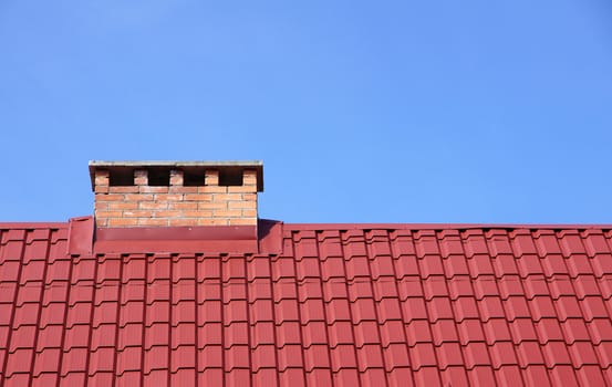 The roof and chimney with blue sky