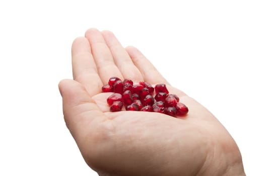 pomegranate in his hand on a white background