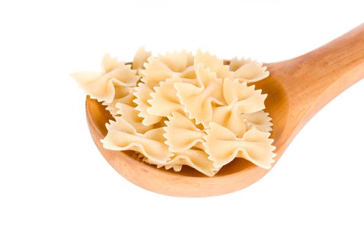 pasta in the form of ribbons in a wooden spoon isolated on a white background