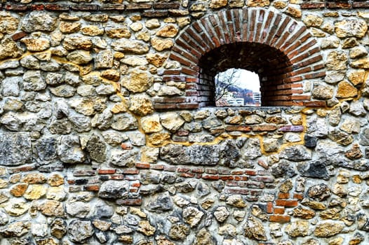 stone and brick wall background with a window