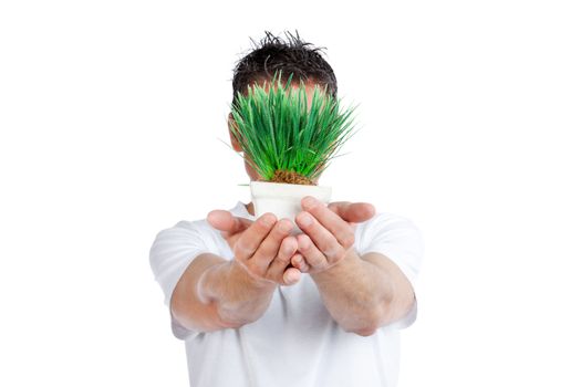 Man holding pot of green plant against white background.