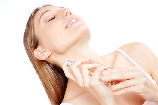 Young woman spraying bottle of perfume.