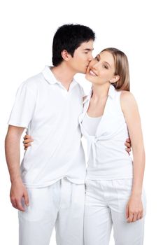 Portrait of young man kissing the young woman isolated on white background.