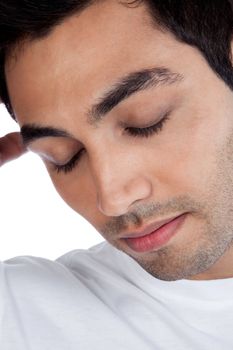 Young stressed man with eye closed isolated on white background.