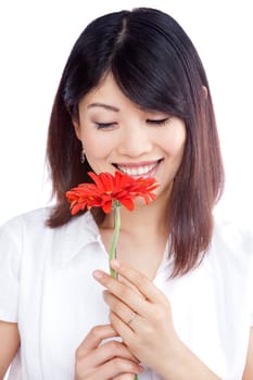 Young happy woman holding gerbera flower isolated on white background.