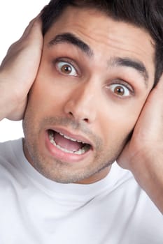 Young Asian man covering his ears isolated on white background.