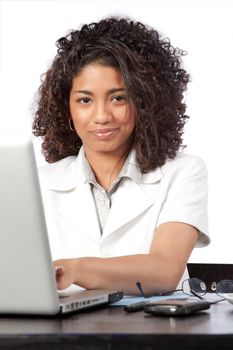 Portrait of female doctor using laptop at work isolated on white background.