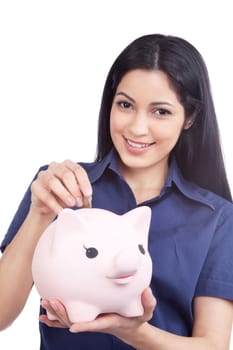 Smiling woman holding piggy bank and coin isolated on white background.