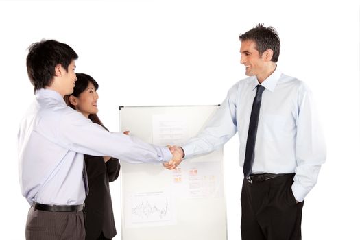 Smiling businesswoman and businessman shaking hand at presentation in office.