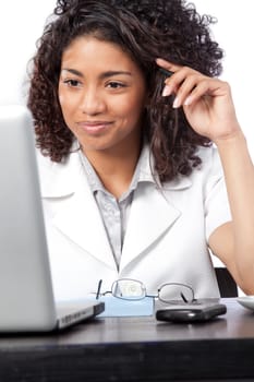 Portrait of female doctor using laptop at work isolated on white background.