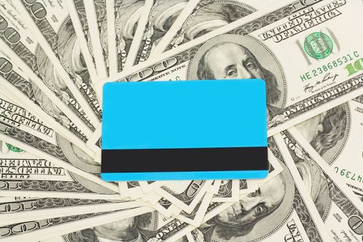 blue plastic card against dollar