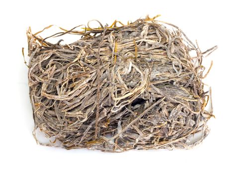 A pile of dried laminaria (kelp) isolated on a white background 