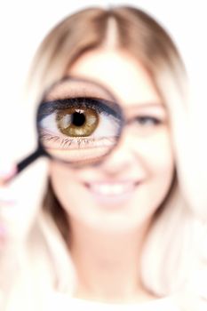 attractive caucasian girl with loupe on her eye