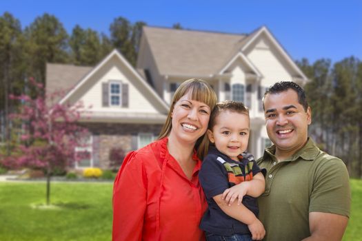 Happy Mixed Race Young Family in Front of Beautiful House.