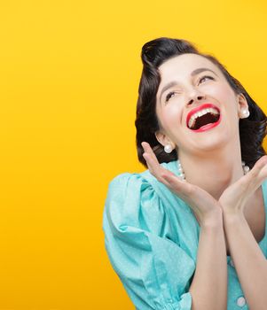 Portrait of happy woman on yellow background