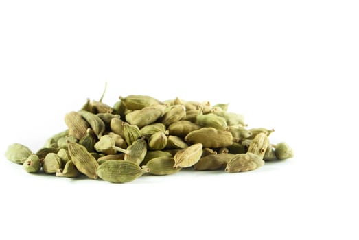 Pile of whole cardamom on white background