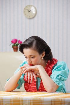 Portrait of a depressed housewife in the kitchen