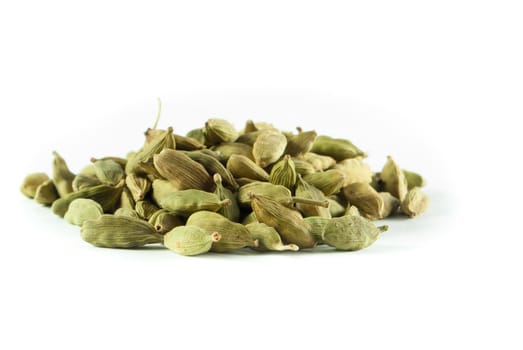 Pile of whole cardamom on white background
