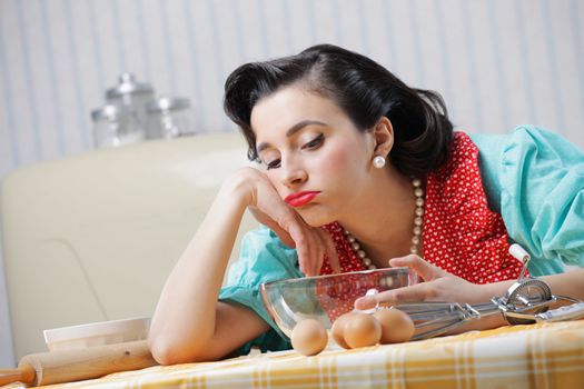 Portrait of a bored housewife in the kitchen