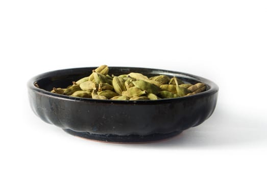 Pile of whole cardamom on white background