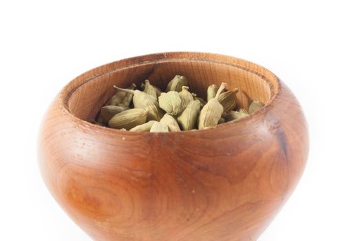 Pile of whole cardamom on white background