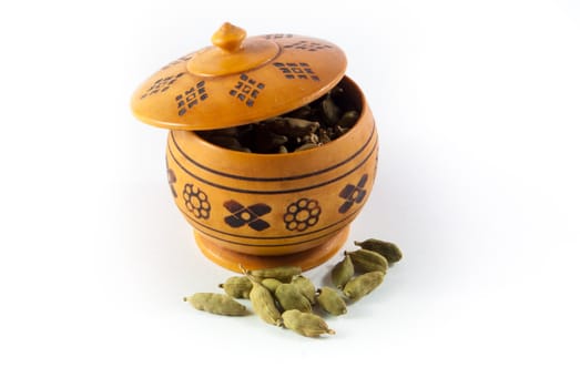 Pile of whole cardamom on white background