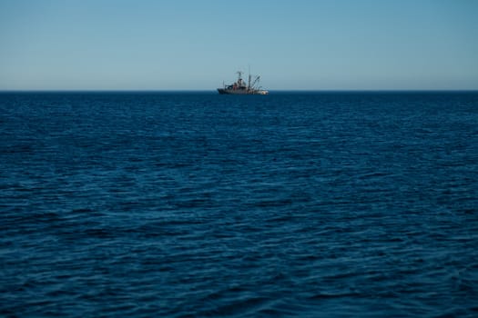 Far away Canadian army ship in the ocean
