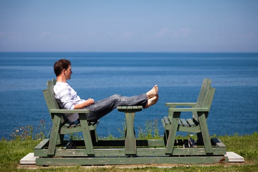 Man having a beautiful moment on a bench in vacation