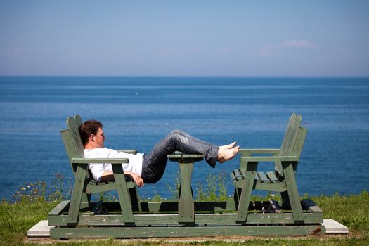 Sleeping man alone on a bench in vacation