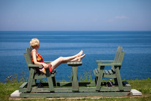 Girl having a beautiful moment on a bench in vacation