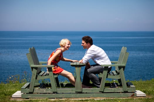 Romantic couple laughing together on the bench