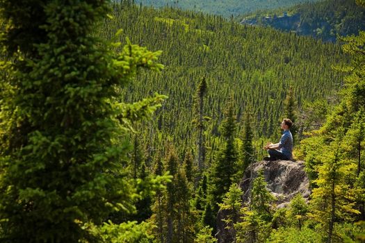 Yoga on a rock in the middle of the nature